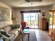 Bright living room with tile floors, comfortable seating, and a view of the lake from the screened patio at 4000 Oakview Dr # L2, Punta Gorda, FL 33980