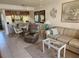 Well-lit living area with open layout to kitchen, tile floors, comfortable furniture, and appealing decor at 4000 Oakview Dr # L2, Punta Gorda, FL 33980