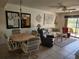 Comfortable living room with ceiling fan, tile floors, and a cozy seating arrangement overlooking a patio at 4000 Oakview Dr # L2, Punta Gorda, FL 33980