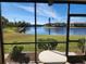 Screened-in patio showcasing a serene lake view, offering a tranquil outdoor living space at 4000 Oakview Dr # L2, Punta Gorda, FL 33980