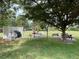 Outdoor picnic area with tables, chairs, and a grill at 4000 Oakview Dr # L2, Punta Gorda, FL 33980