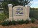 Community entrance sign for Tala Lake, a 55+ community, surrounded by lush greenery and manicured landscaping at 4000 Oakview Dr # L2, Punta Gorda, FL 33980