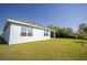 Lush backyard with green grass and a view of the home's exterior at 421 San Cristobal Ave, Punta Gorda, FL 33983