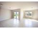 Spacious living room featuring tiled floors, sliding glass doors to the backyard, and natural light at 421 San Cristobal Ave, Punta Gorda, FL 33983