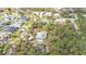 An aerial view of a property surrounded by lush greenery in a residential neighborhood at 4334 Sandune Ave, North Port, FL 34287