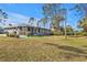 Expansive backyard featuring a screened patio and lush landscaping at 4334 Sandune Ave, North Port, FL 34287