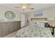 Bedroom featuring a decorative mirror, dresser, and bed with beach-themed decorative pillows at 522 Lomond Dr, Port Charlotte, FL 33953