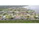 This aerial photo presents many waterfront homes nestled amidst lush green vegetation and waterways at 5244 Early Ter, Port Charlotte, FL 33981