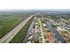 Aerial view of waterfront homes along a canal, showcasing neighborhood layout and proximity to a highway at 5244 Early Ter, Port Charlotte, FL 33981