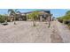 Landscaped backyard features white rock, brick pavers, and a view of the enclosed lanai at 5244 Early Ter, Port Charlotte, FL 33981