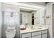 Bright bathroom featuring a single sink vanity, floral wallpaper trim, and a shower at 5244 Early Ter, Port Charlotte, FL 33981