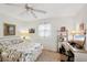 Bright bedroom featuring ceiling fan, windows, desk, and decorative side lamps at 5244 Early Ter, Port Charlotte, FL 33981