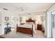 Primary bedroom with a king-sized bed, ceiling fan, and en-suite bathroom at 5244 Early Ter, Port Charlotte, FL 33981