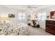 Bright bedroom featuring ceiling fan, windows, desk, and dark wood dresser at 5244 Early Ter, Port Charlotte, FL 33981