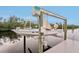 Image features a boat on a lift at a private dock, offering convenient waterfront access and boating opportunities at 5244 Early Ter, Port Charlotte, FL 33981