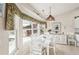 Bright dining area with white table set, coastal decor and large windows overlooking the pool at 5244 Early Ter, Port Charlotte, FL 33981