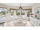 Charming dining room with a white wood table, coastal decor and views of the pool and patio at 5244 Early Ter, Port Charlotte, FL 33981
