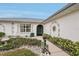 Inviting entrance featuring a detailed facade, arched doorway, and meticulously maintained landscaping at 5244 Early Ter, Port Charlotte, FL 33981