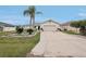Welcoming single-story home featuring a two-car garage, a concrete driveway, and tropical landscaping at 5244 Early Ter, Port Charlotte, FL 33981