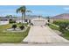 Inviting single-story home showcasing a two-car garage, long driveway, and neatly manicured landscaping at 5244 Early Ter, Port Charlotte, FL 33981