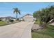 Nice one-story home featuring a two-car garage, concrete driveway, and lush landscaping including a mature tree at 5244 Early Ter, Port Charlotte, FL 33981