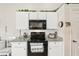 Cozy kitchen featuring white cabinets, granite countertops, and modern stainless steel appliances at 5244 Early Ter, Port Charlotte, FL 33981