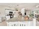 Kitchen with white cabinetry, granite countertops, breakfast bar and open view to the living space at 5244 Early Ter, Port Charlotte, FL 33981