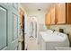 Bright laundry room features cabinetry above the washer and dryer for extra storage at 5244 Early Ter, Port Charlotte, FL 33981