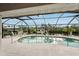 This pool is enclosed by a lanai with a beautiful view and outdoor furniture at 5244 Early Ter, Port Charlotte, FL 33981