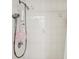 Close-up of tiled shower stall featuring adjustable shower head and mounted storage unit at 5244 Early Ter, Port Charlotte, FL 33981