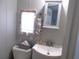 Bathroom featuring a vanity with a mirror and window, and a nearby toilet at 5632 Holiday Park Blvd, North Port, FL 34287