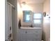 Bathroom featuring a vanity with a mirror and natural light from the window above the sink at 5632 Holiday Park Blvd, North Port, FL 34287