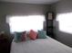 Bright bedroom featuring a comfortable bed, decorative pillows, and natural light from the windows at 5632 Holiday Park Blvd, North Port, FL 34287