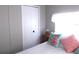 Inviting bedroom with a comfortable bed, decorative pillows, and a white closet at 5632 Holiday Park Blvd, North Port, FL 34287