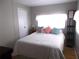Inviting bedroom with a comfortable bed, decorative pillows, and natural light from the window at 5632 Holiday Park Blvd, North Port, FL 34287