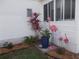 Charming landscaping with a pink flamingo and vibrant plants enhances the curb appeal of this home at 5632 Holiday Park Blvd, North Port, FL 34287