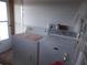 Efficient laundry room with modern washer and dryer, offering convenience and functionality at 5632 Holiday Park Blvd, North Port, FL 34287