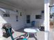 This covered patio with seating is perfect for outdoor relaxation and enjoying serene views at 5632 Holiday Park Blvd, North Port, FL 34287