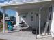 Relaxing covered patio with seating, grill, and serene outdoor views for leisure and entertaining at 5632 Holiday Park Blvd, North Port, FL 34287