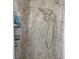 Shower with beige marble surround, updated fixture, and convenient shelving for toiletries at 5632 Holiday Park Blvd, North Port, FL 34287