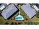 Aerial view of condo complex with a pool and manicured green spaces between buildings at 5725 Greenwood Ave # 3104, North Port, FL 34287