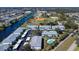 An aerial view of several condo buildings near a river, baseball field, and community pool at 5725 Greenwood Ave # 3104, North Port, FL 34287