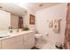 Bright bathroom with white tile flooring, vanity, mirror, and decorative towels at 5725 Greenwood Ave # 3104, North Port, FL 34287