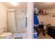 Bright bathroom with a glass-enclosed shower and storage space at 5725 Greenwood Ave # 3104, North Port, FL 34287