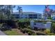 Exterior view of Coco Plum Condominiums with lush landscaping and a community sign at 5725 Greenwood Ave # 3104, North Port, FL 34287