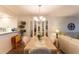 Cozy dining area featuring a chandelier and views to the open living spaces at 5725 Greenwood Ave # 3104, North Port, FL 34287