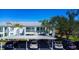 Exterior view of condo building with well-maintained landscaping and carport parking at 5725 Greenwood Ave # 3104, North Port, FL 34287