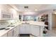 A modern white kitchen with stainless steel appliances and a view into the living area at 5725 Greenwood Ave # 3104, North Port, FL 34287