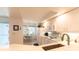 Bright kitchen features white cabinets, modern appliances, and a cozy breakfast nook at 5725 Greenwood Ave # 3104, North Port, FL 34287