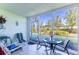 Enclosed lanai featuring tiled floors, seating, and a beautiful view of the outdoors at 5725 Greenwood Ave # 3104, North Port, FL 34287